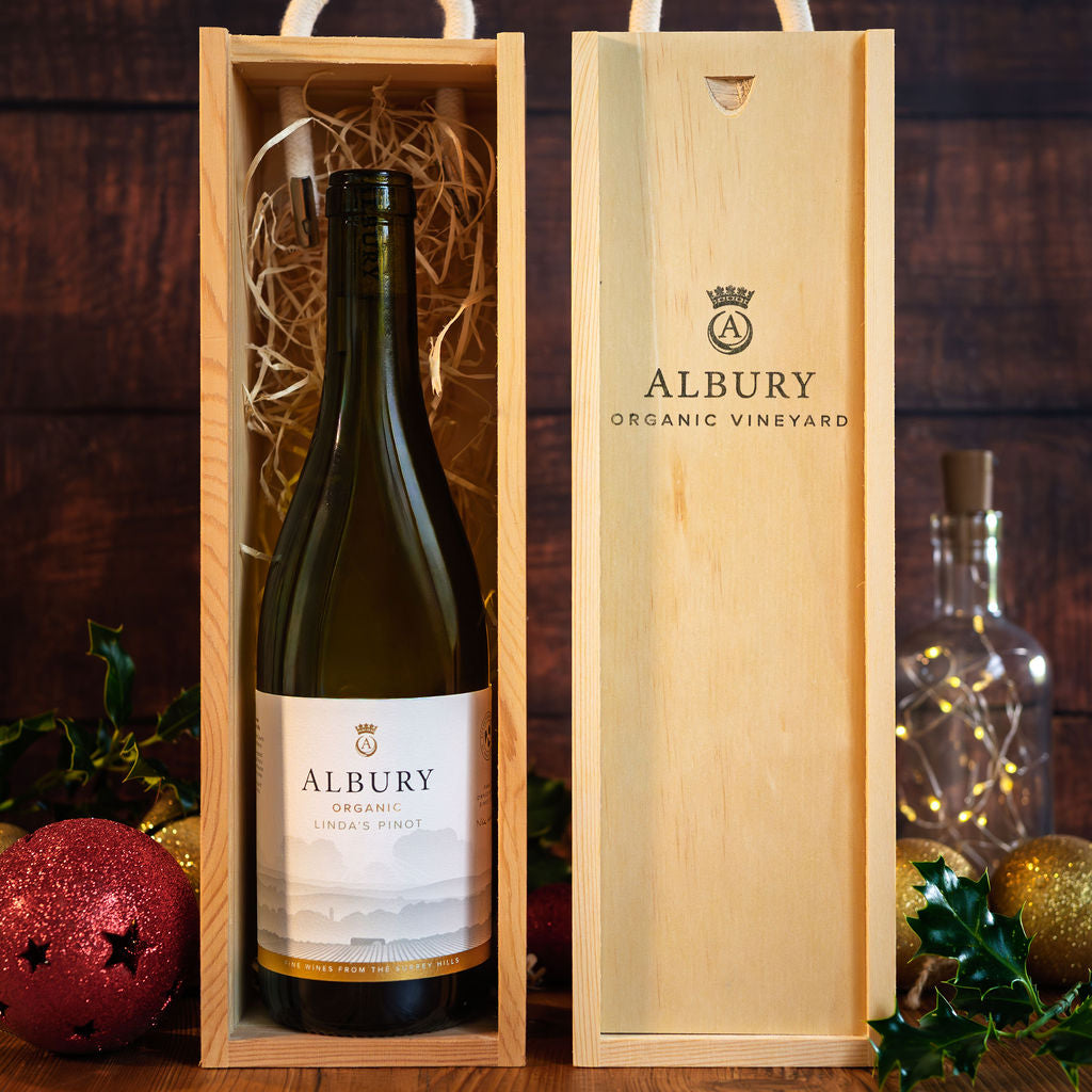 Albury Organic Vineyard wine bottle in a wooden box with festive decorations.